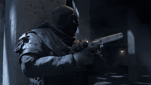 A Man Wearing A Mask Is Pointing A Gun At Something GIF