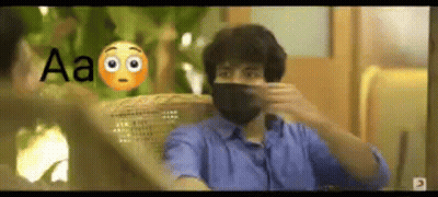 A Man Wearing A Mask Is Sitting In A Chair And Talking To Another Man . GIF