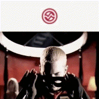 A Man Wearing A Mask Is Sitting In Front Of A Bull 'S Horns .. GIF