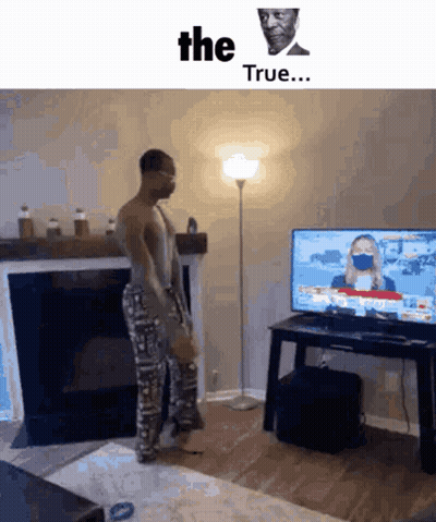 A Man Wearing A Mask Is Standing In Front Of A Television With The Words " The True " On The Bottom GIF