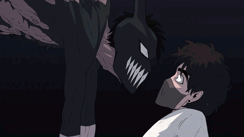 A Man Wearing A Mask Looks At A Monster With Sharp Teeth GIF