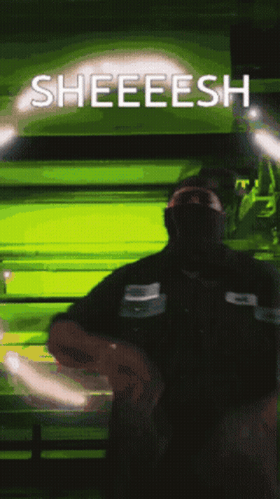 A Man Wearing A Mask Stands In Front Of A Green Background That Says Sheeesh GIF