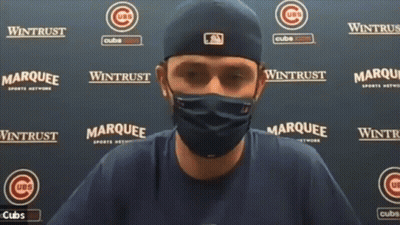 A Man Wearing A Mask Stands In Front Of A Wall That Says ' Marquee ' On It GIF