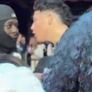 A Man Wearing A Mask Talks To Another Man GIF