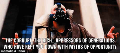 A Man Wearing A Mask With A Quote That Says The Corrupt The Rich Oppressors Of Generations Who Have Kept You Down GIF