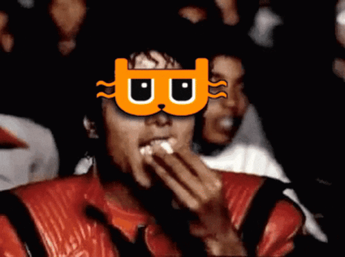 A Man Wearing A Mask With The Letter B On It Eating Popcorn GIF