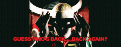A Man Wearing A Mask With The Words Guess Who 'S Back Back Again Behind Him GIF