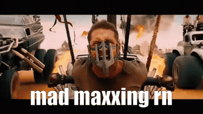 A Man Wearing A Mask With The Words Mad Maxxing Rn Written Below Him GIF