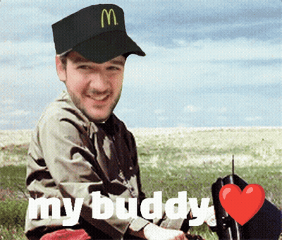 A Man Wearing A Mcdonald 'S Hat Is Sitting In The Grass GIF