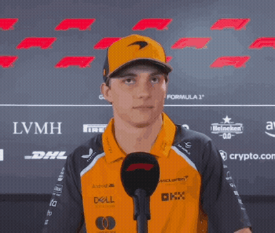 A Man Wearing A Mclaren Hat And A Dell Shirt Is Talking Into A Microphone GIF
