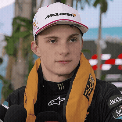 A Man Wearing A Mclaren Hat And A Scarf Around His Neck GIF