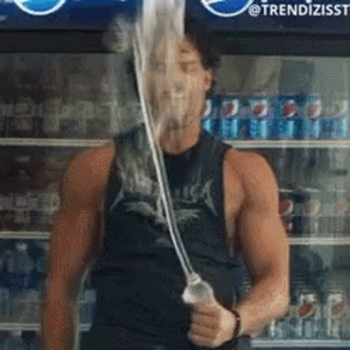 A Man Wearing A Metallica Shirt Is Holding A Straw In Front Of A Pepsi Fridge GIF