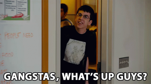 A Man Wearing A Metallica Shirt Is Standing In A Doorway With The Words Gangstas What 'S Up Guys GIF