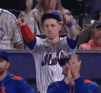 A Man Wearing A Mets Jersey Is Pointing At Something GIF