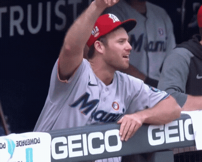 A Man Wearing A Miami Baseball Jersey Stands In The Dugout GIF