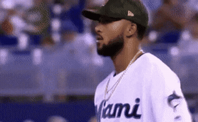 A Man Wearing A Miami Jersey And A Hat GIF
