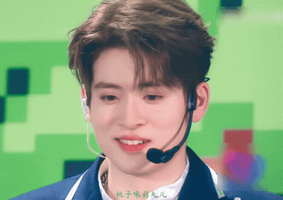 A Man Wearing A Microphone With Chinese Writing On The Bottom GIF