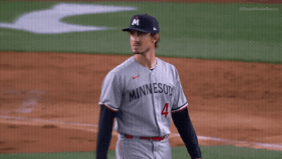 A Man Wearing A Minnesota Jersey Stands On The Field GIF
