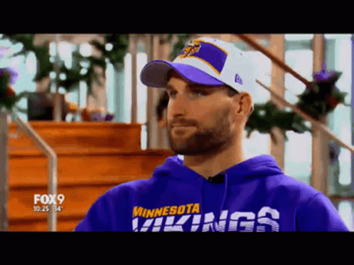 A Man Wearing A Minnesota Vikings Hoodie GIF