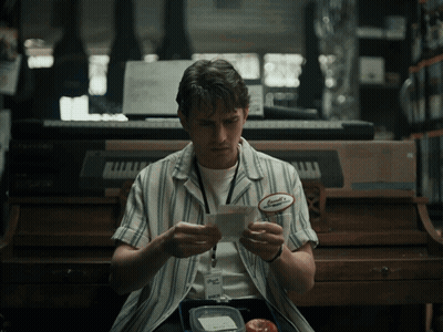 A Man Wearing A Name Tag That Says Samuel On It GIF