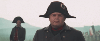 A Man Wearing A Napoleon Hat Stands In Front Of Another Man Wearing A Napoleon Hat GIF