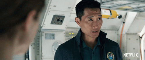 A Man Wearing A Nasa Shirt Is Talking To Another Man GIF