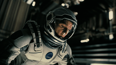A Man Wearing A Nasa Space Suit Looks Down GIF