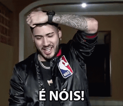 A Man Wearing A Nba Jacket Is Holding His Hand To His Head And Smiling . GIF