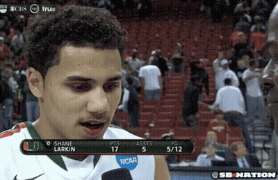 A Man Wearing A Ncaa Jersey Is Talking To A Reporter GIF