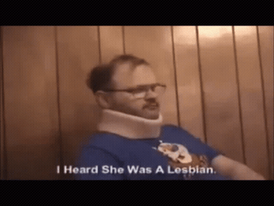 A Man Wearing A Neck Brace And Glasses Is Talking About Being A Lesbian . GIF