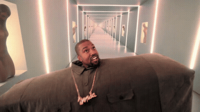 A Man Wearing A Necklace That Says ' Kanye West ' On It GIF