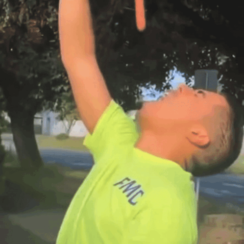 A Man Wearing A Neon Green Shirt With Fmc Written On It GIF