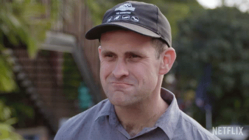 A Man Wearing A Netflix Hat Is Making A Face GIF