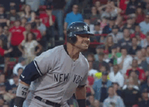 A Man Wearing A New York Jersey Is Standing In Front Of A Crowd GIF