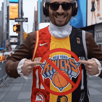 A Man Wearing A New York Knicks Jersey Points To A Red Circle GIF