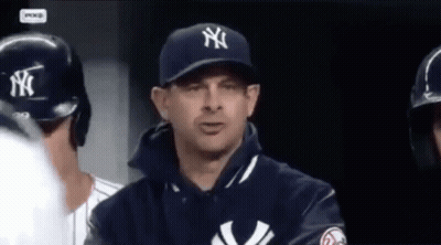 A Man Wearing A New York Yankees Hat And Jacket GIF
