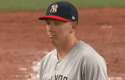 A Man Wearing A New York Yankees Hat Looks At Something GIF