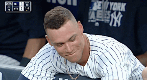 A Man Wearing A New York Yankees Shirt Looks Down GIF