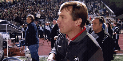 A Man Wearing A Nike Jacket With The Letter G On The Front GIF