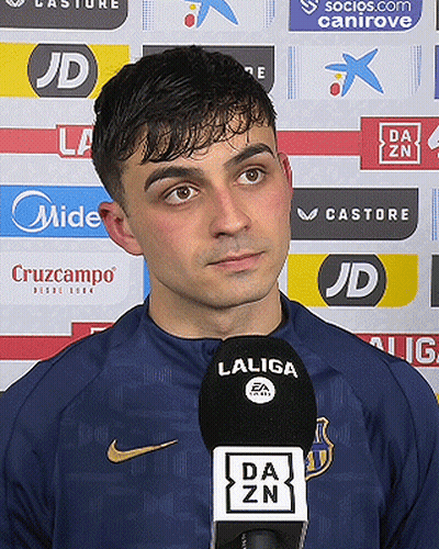 A Man Wearing A Nike Shirt Is Talking Into A Laliga Microphone . GIF