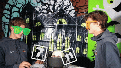 A Man Wearing A Nike Sweatshirt Is Standing Next To Another Man Wearing Green Glasses GIF