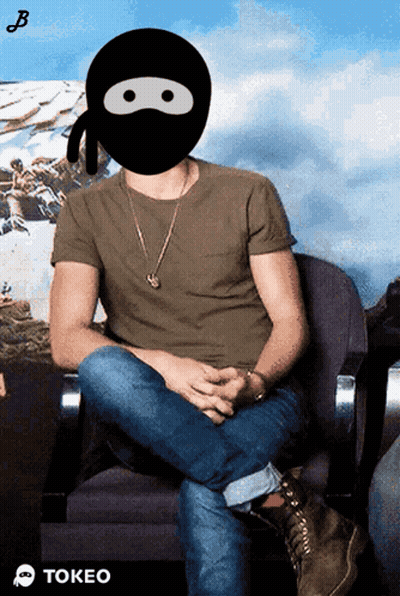 A Man Wearing A Ninja Mask Is Sitting In A Chair With The Word Tokeo Below Him GIF
