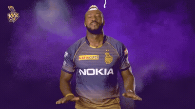 A Man Wearing A Nokia Shirt Stands In Front Of A Purple And Yellow Background GIF