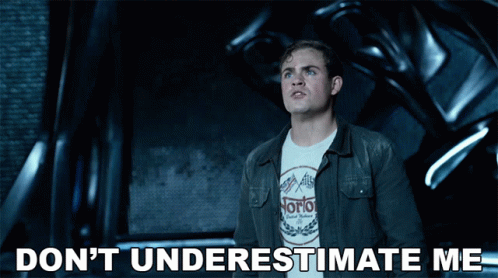 A Man Wearing A Norton Shirt Is Standing In Front Of A Machine GIF