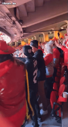 A Man Wearing A Number 2 Jersey Stands In A Crowded Stadium GIF