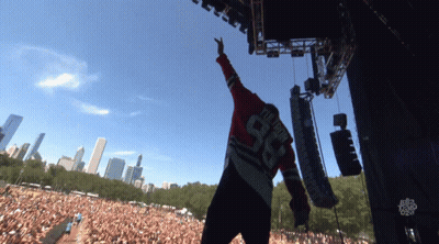 A Man Wearing A Number 98 Jersey Stands On Stage GIF