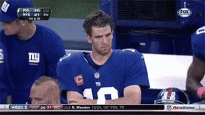 A Man Wearing A Ny Giants Jersey Sits In The Stands GIF