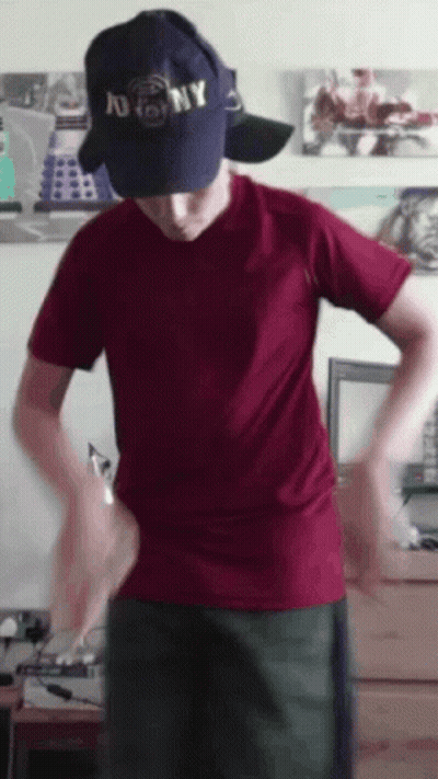 A Man Wearing A Ny Hat And A Red Shirt GIF