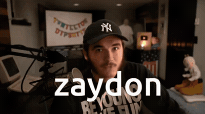 A Man Wearing A Ny Hat Stands In Front Of A Microphone With The Name Zaydon On The Bottom GIF