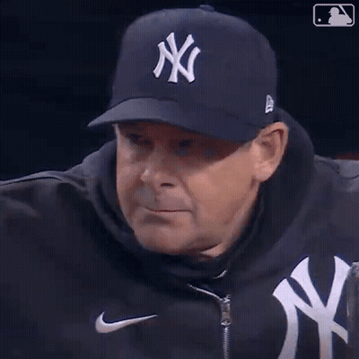 A Man Wearing A Ny Yankees Hat And A Nike Jacket GIF
